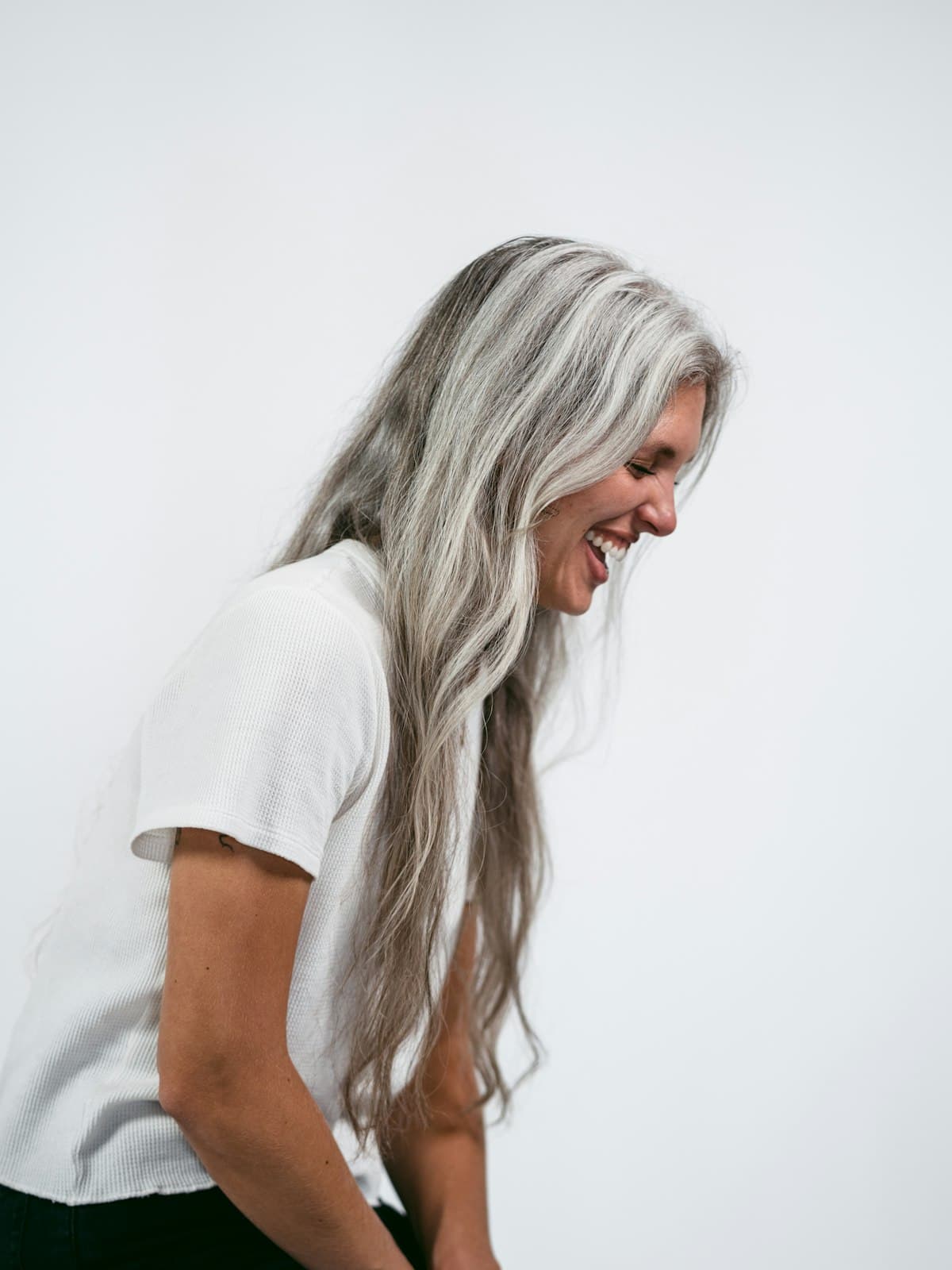 A woman with long grey hair in daylight